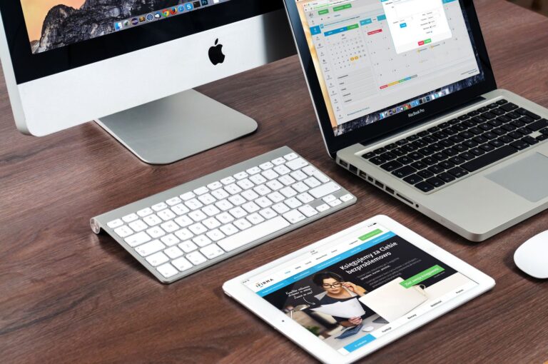 Desk setup with desktop computer, laptop and tablet