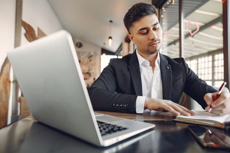 Professional taking notes while working on a project