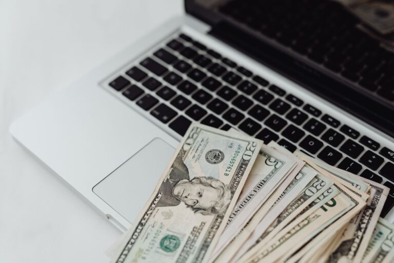 Banknotes resting on a laptop keyboard