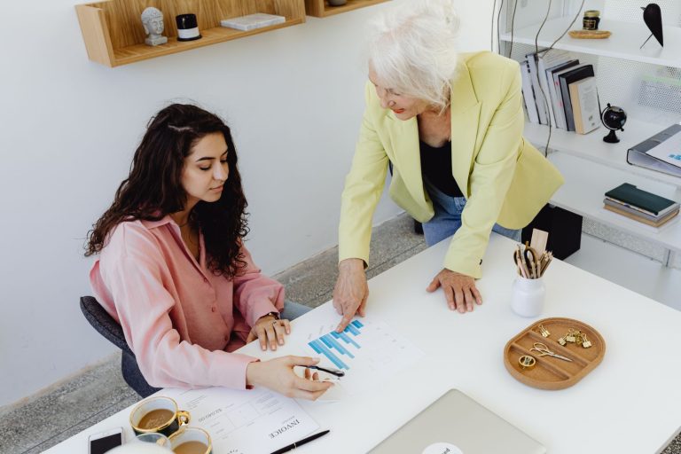 Two colleagues reviewing business figures in an office